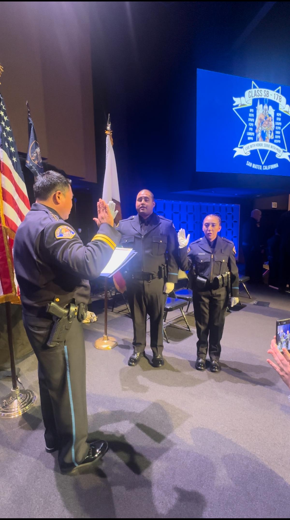 Officers Cesar Flores-Garcia and Guadalupe Juarez being sworn in as East Palo Alto Police Officers